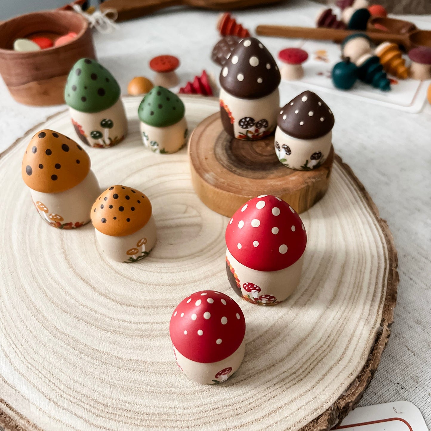 Colorful wooden mushroom toys on a wooden surface with a blurred background