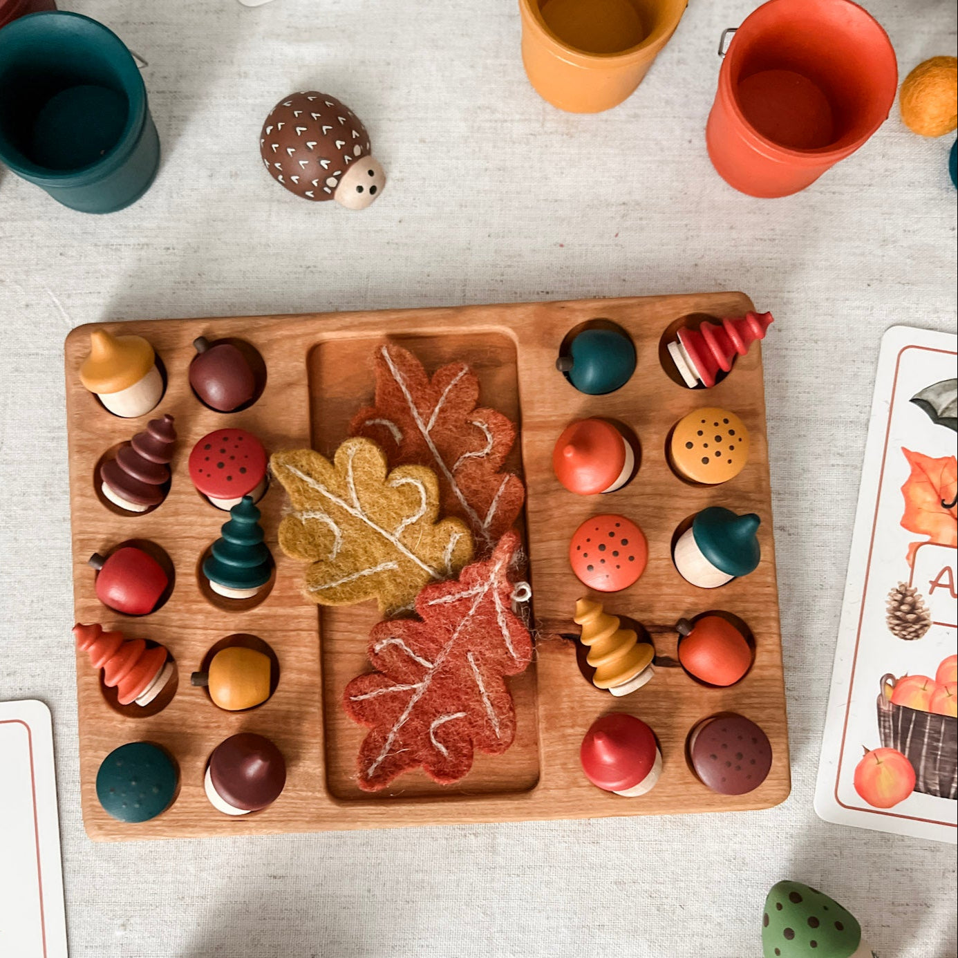 Wooden toy set with colorful pieces on a light surface