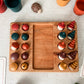 Wooden game board with colorful animal figurines on a light gray surface.