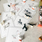 Educational animal cards with corresponding toy animals on a textured surface
